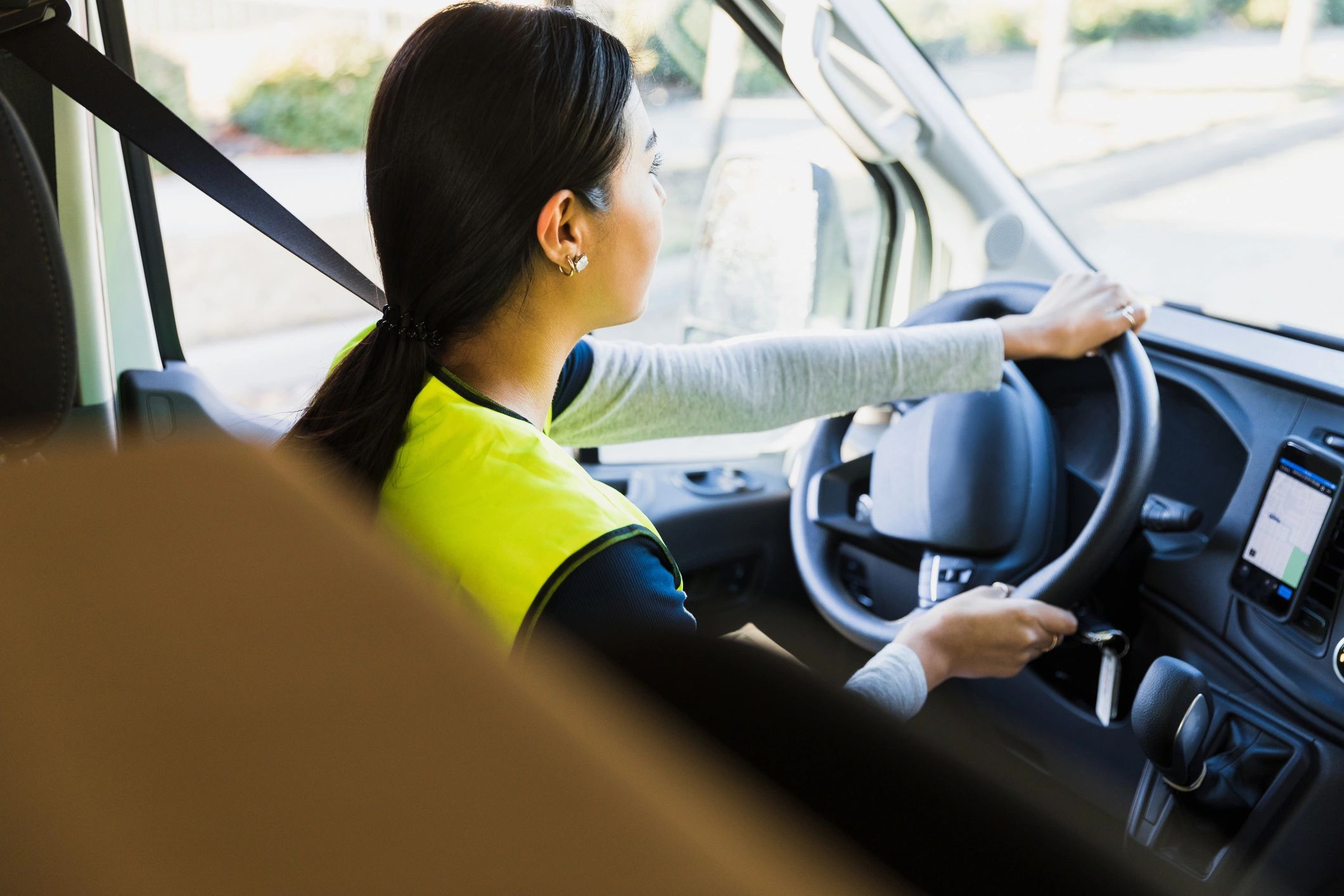 Driver using navigation app in city traffic
