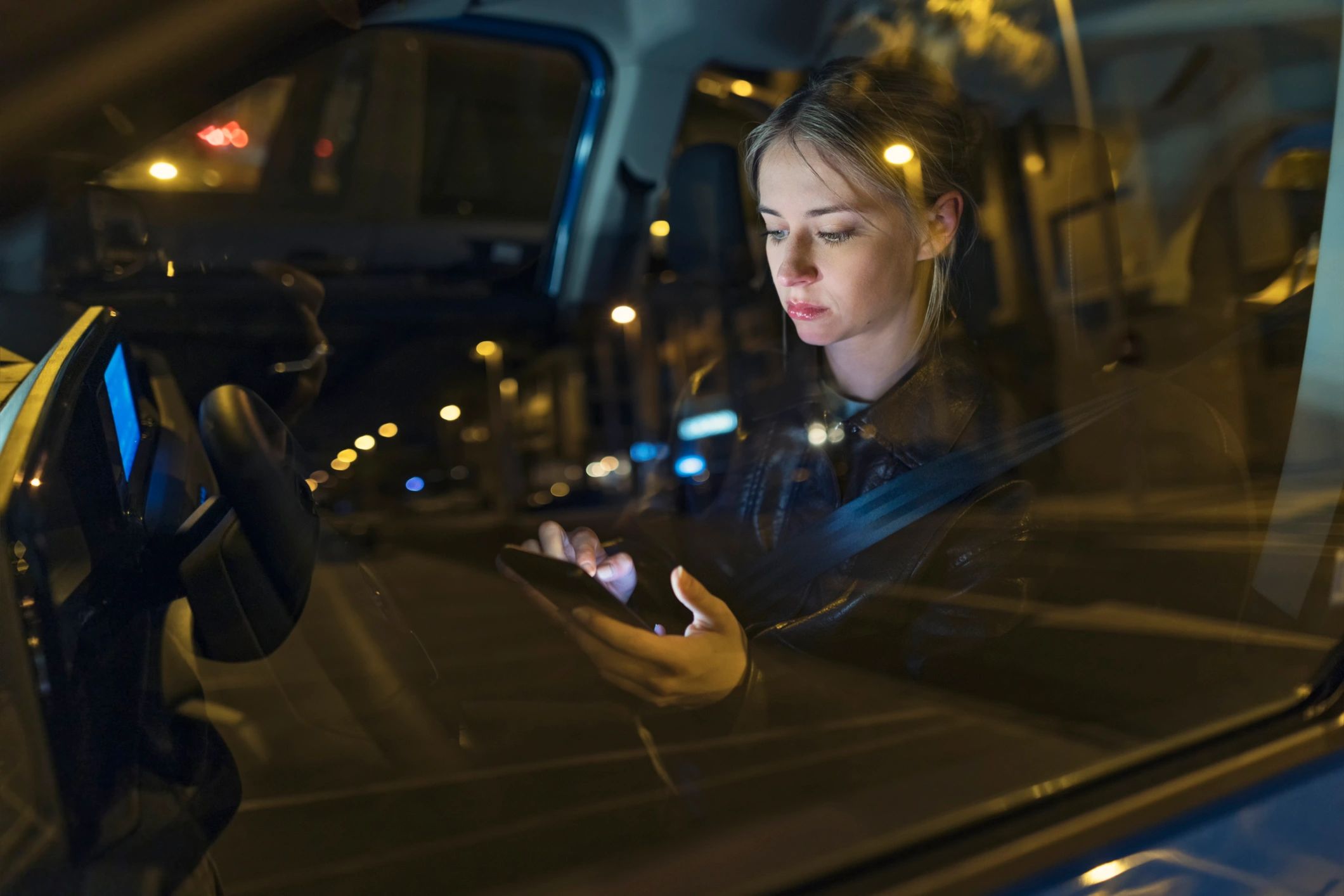 Driver preparing route in a car at night